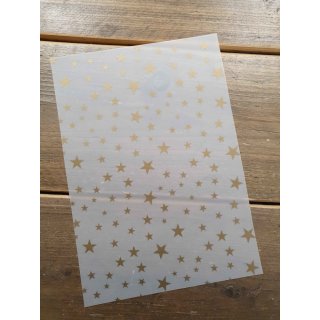 weißes Transparentpapier mit goldenen Sternen